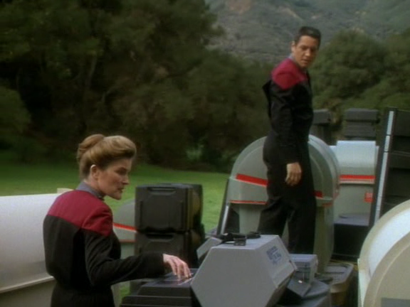 Janeway and a large expressionless plastic figure (Chakotay) standing around some camping-or-something equipment in the middle of the park next to Paramount Studios sometime in the late 90s.