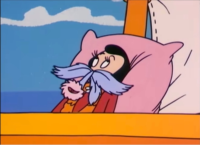 Olive Oyl, laying back on a pillow on a small sailboat, holding an orchid up so that it looks like a mustache and mouth on an extended snout.