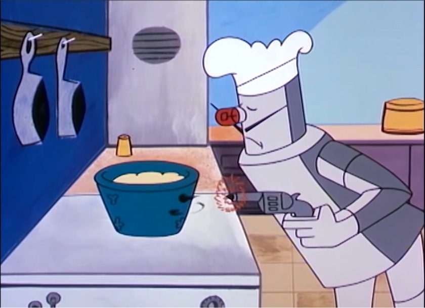 A robot wearing a chef's hat, with long 'French' moustaches, shoots a gun at a bucket full of pancake batter on the stovetop.
