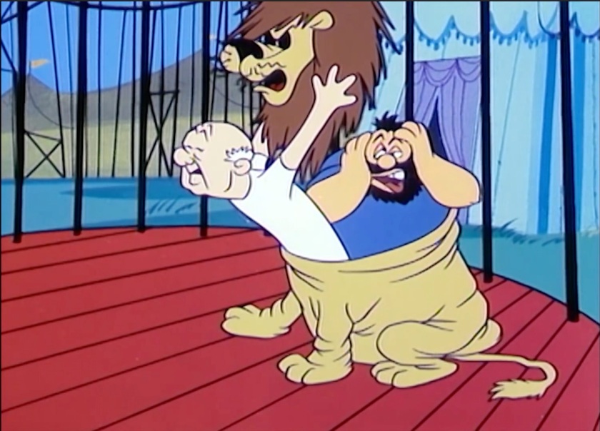 The lion, inside the circus cage, is revealed to be a man in a costume. Brutus is in the back of the costume, looking dazed and confused and patting his face. The man taking off the costume resembles Mr Magoo.
