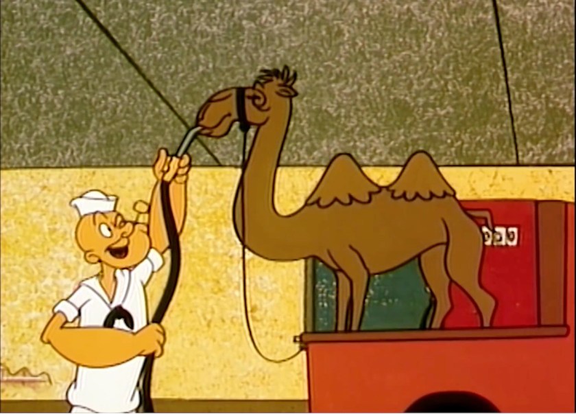 Popeye holding a water hose up to the mouth of a camel standing in the back of a truck bed.