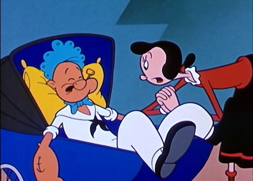 Popeye, wearing a baby bonnet, lies in a baby carriage, looking sad to the point of crying. Olive Oyl stands over him, worried.