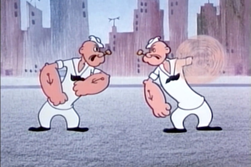 An angry Popeye talks to his robot duplicate. The robot Popeye is spinning an arm, ready to punch.