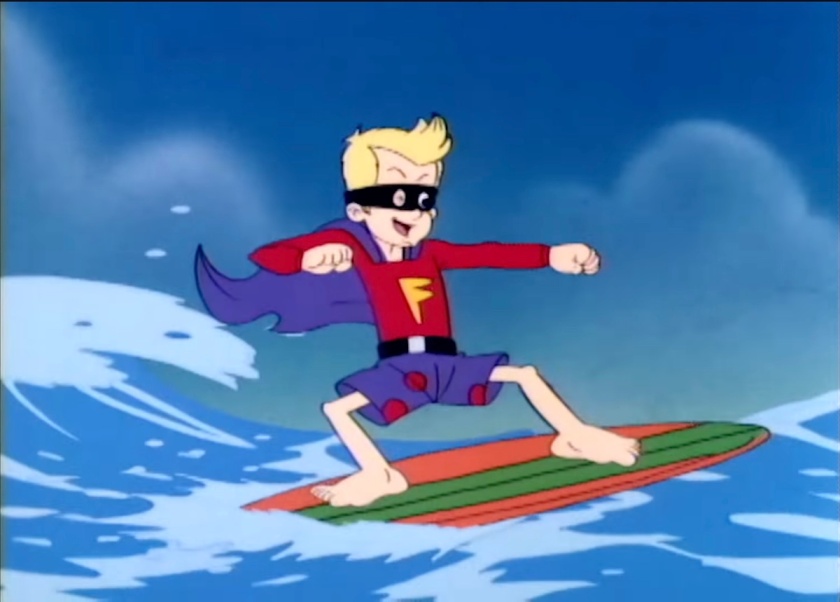 Junior, dressed as the Phantom (or Fantom) Surfer --- poka-dotted blue trunks, red shirt with a big 'F' on it, purple cape behind, and eyemask --- rides a green-and-orange surfboard on the waves.