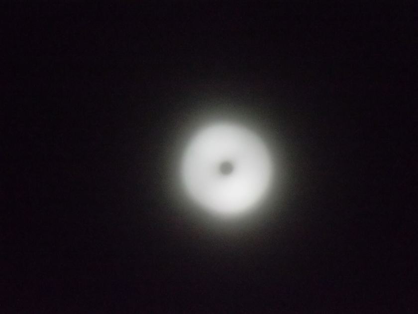 Blurry, overexposed photograph of totality of a solar eclipse. It looks like a fuzzy, glowing white washer around a black center, on a black background. It would be hard-pressed to be less of an eclipse photograph.